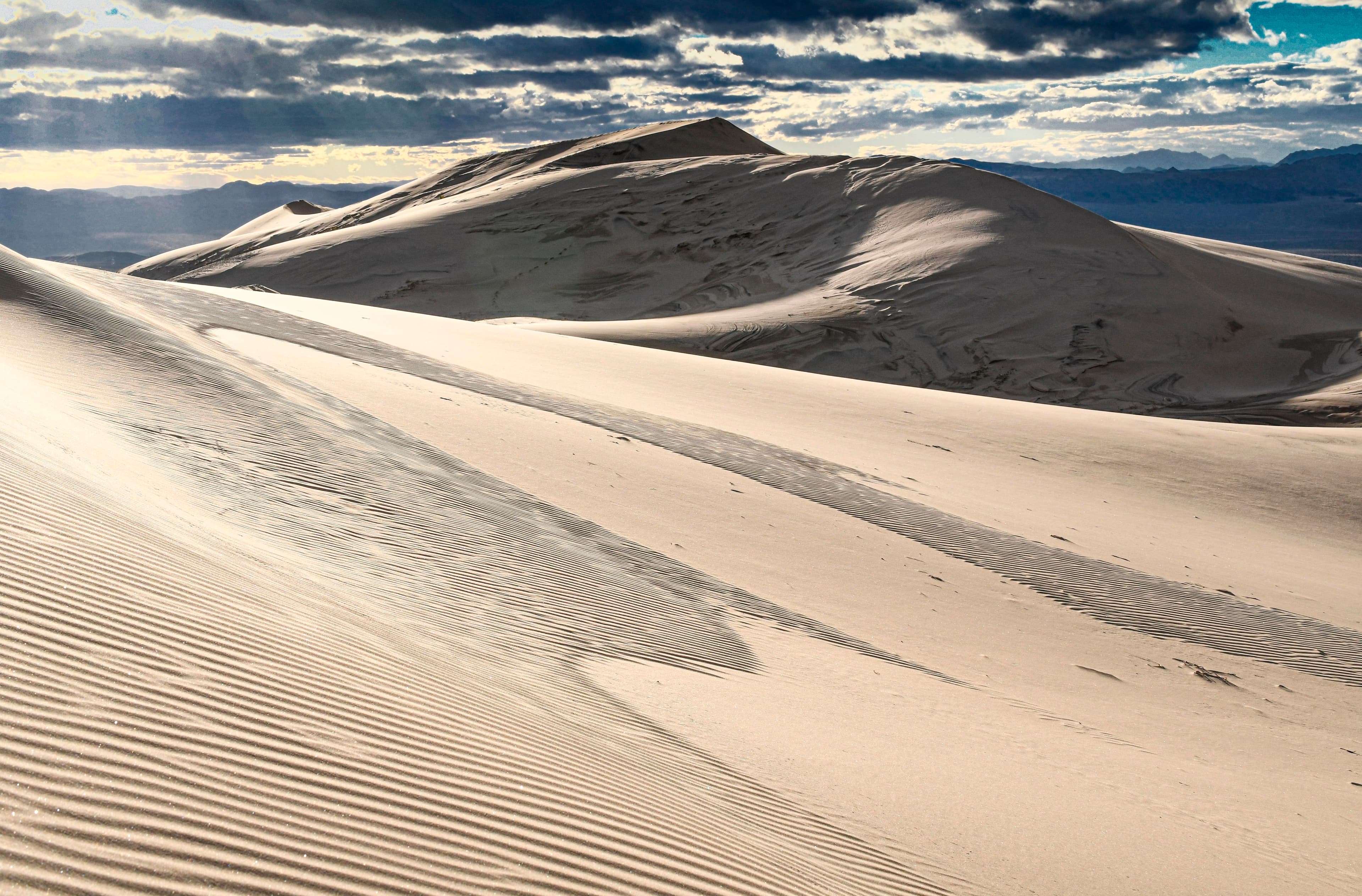 Kelso Dunes with rays of light in Mojave National Preserve.